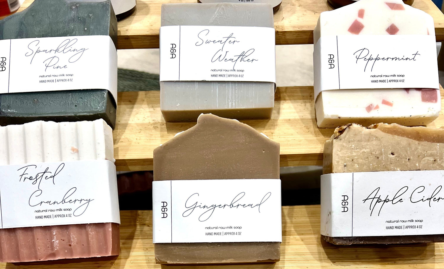 Assorted soaps with labels on a wooden shelf